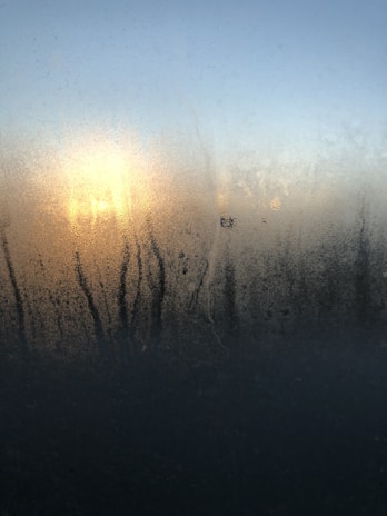 Bright, clean window with sunlight streaming through, showing streak-free shine.