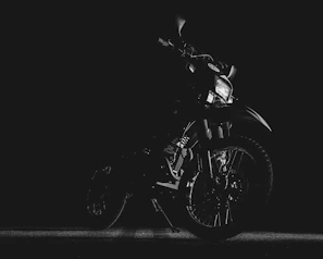 Vibrant image of motorcycle headlights shining brightly on a dark background.