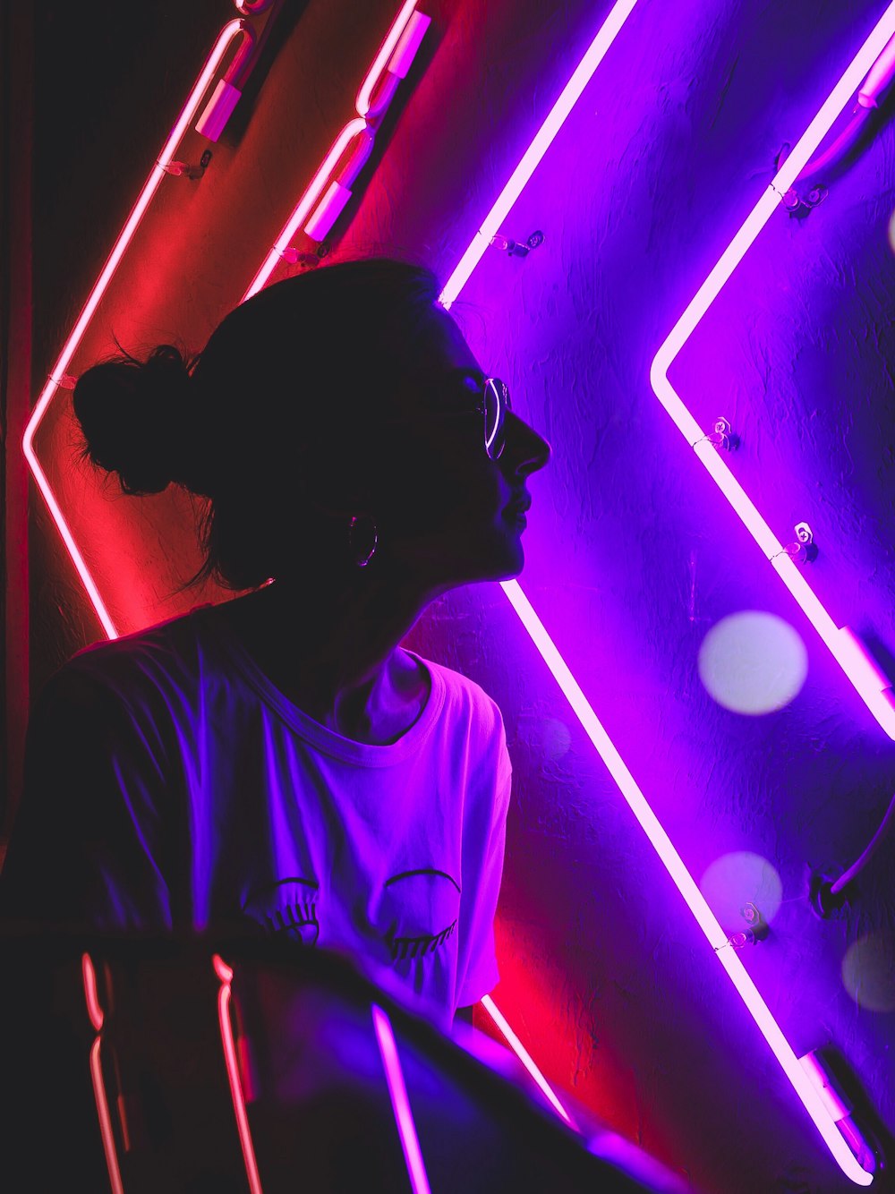 woman sitting near LED signage