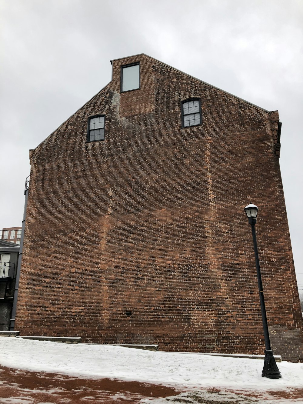 brown concrete building under cloudy sky during daytime