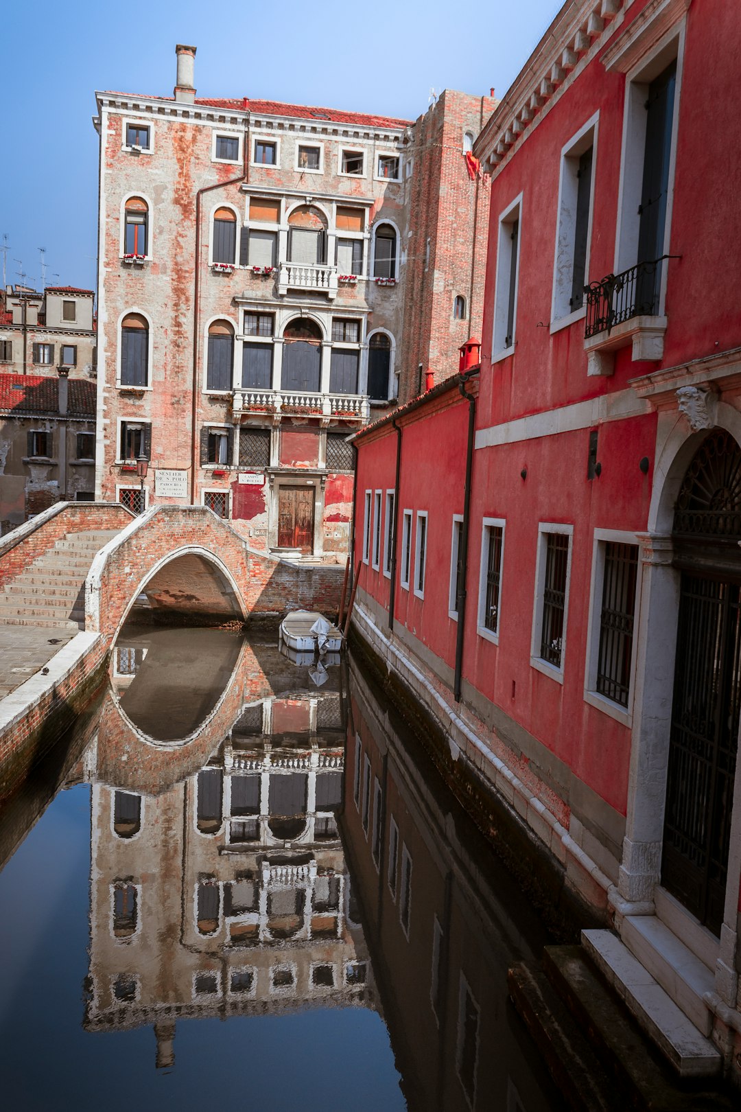 brown and red concrete buildings beside body of water during daytime