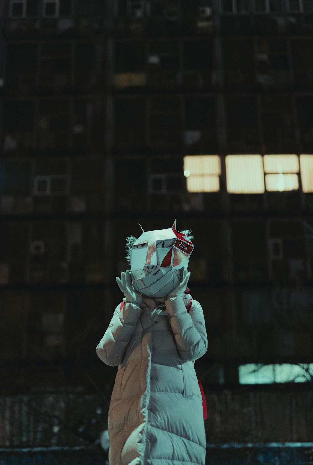 person wearing white coat standing near buildings