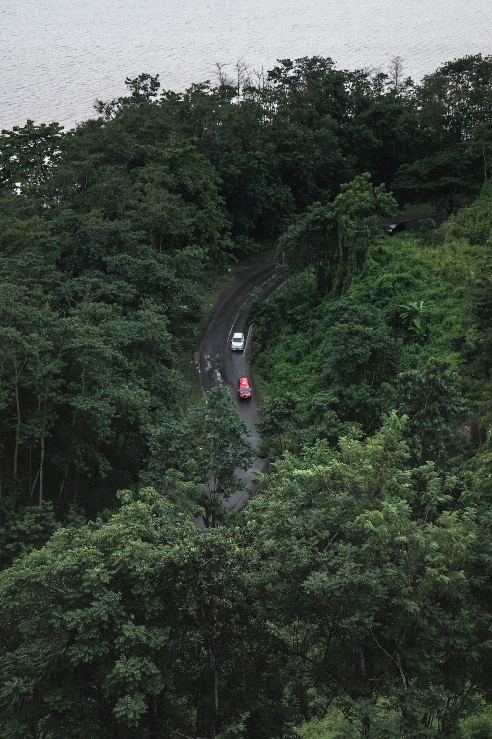 winding road near calm body of water