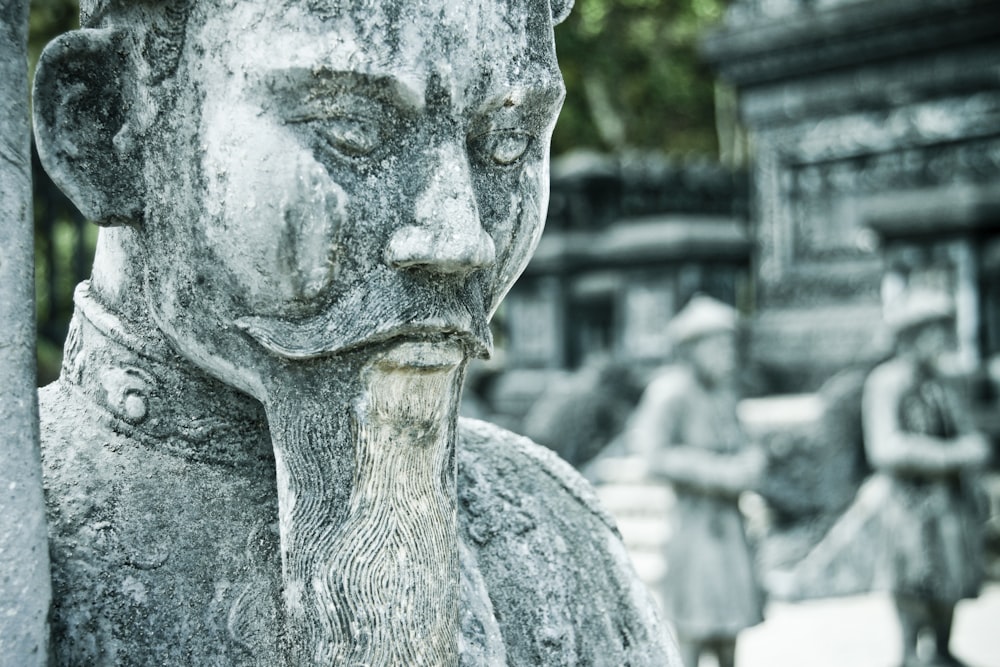 selective focus photography of gray concrete statue