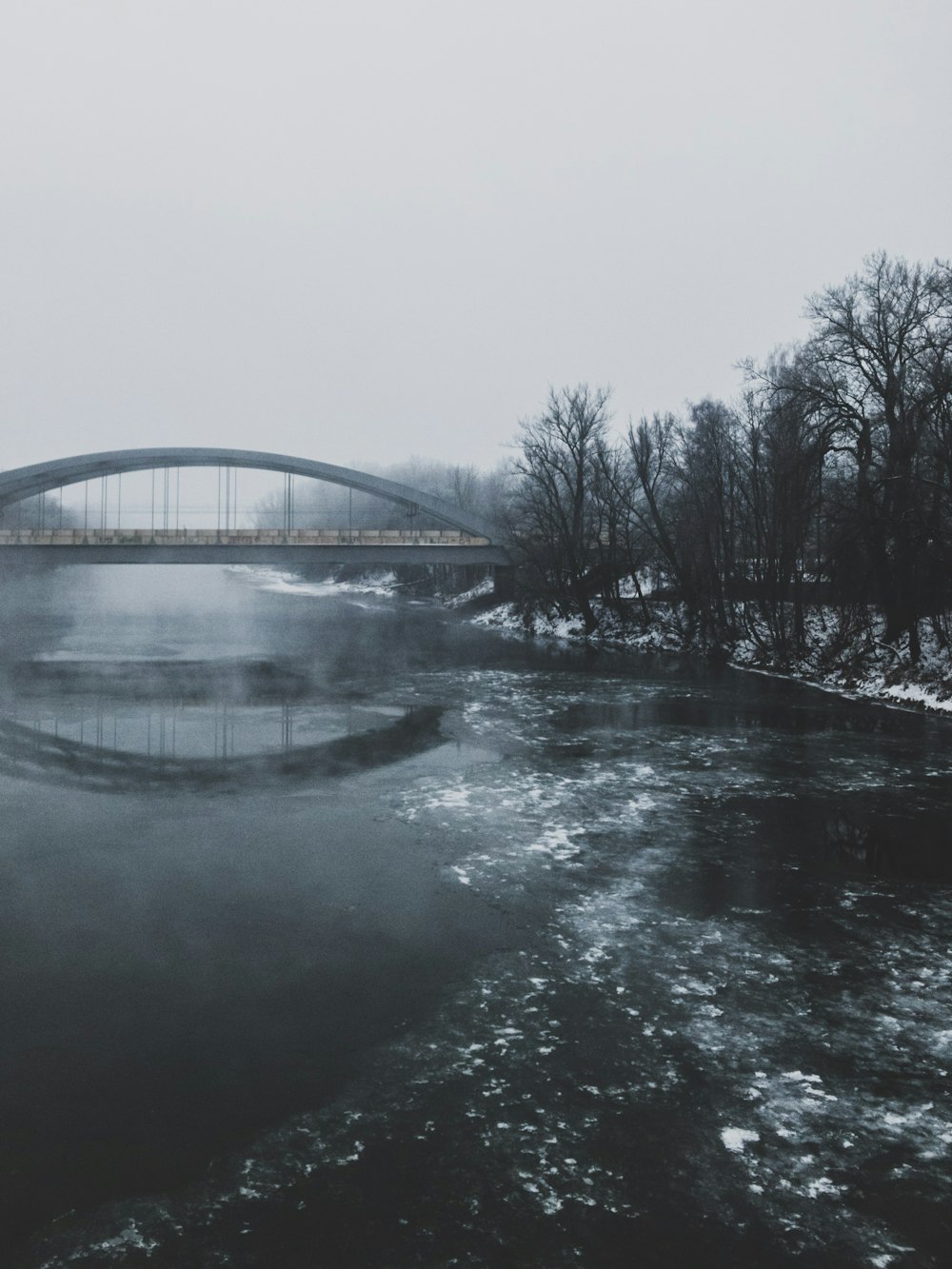 body of water and concrete bridge during daytime