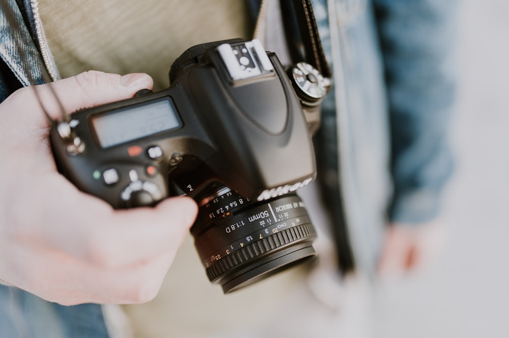 person holding Nikon bridge camera