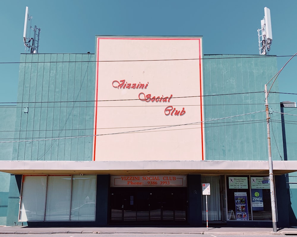 the front of a building with a sign on the side of it