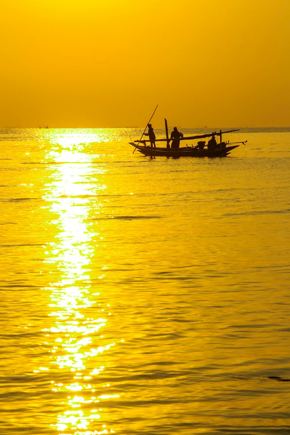 people on boat during golden hour