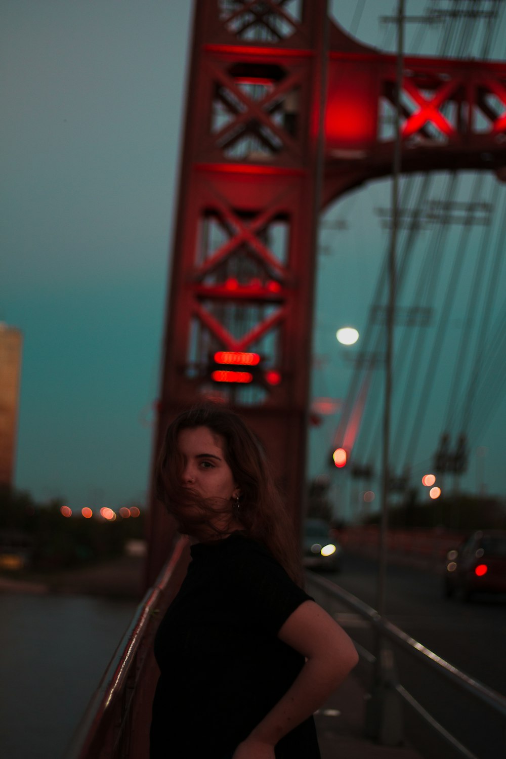 woman standing near red bridge arch