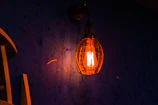 Close-up of a handcrafted pendant light glowing warmly above a cozy nursery corner.