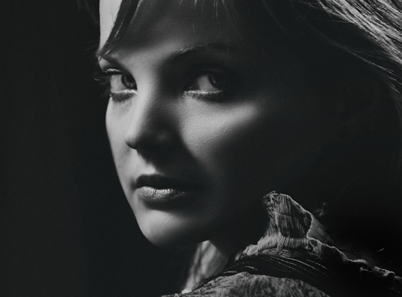 A striking black-and-white portrait showcasing intense emotion and fine detail of a subject's face.