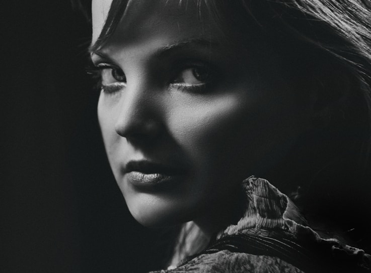 A crisp black-and-white portrait capturing the subtle emotion in a subject's eyes.