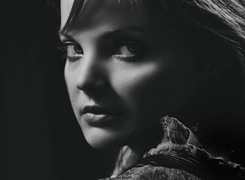 A striking black and white portrait of a person caught in a candid moment, highlighting subtle emotions.