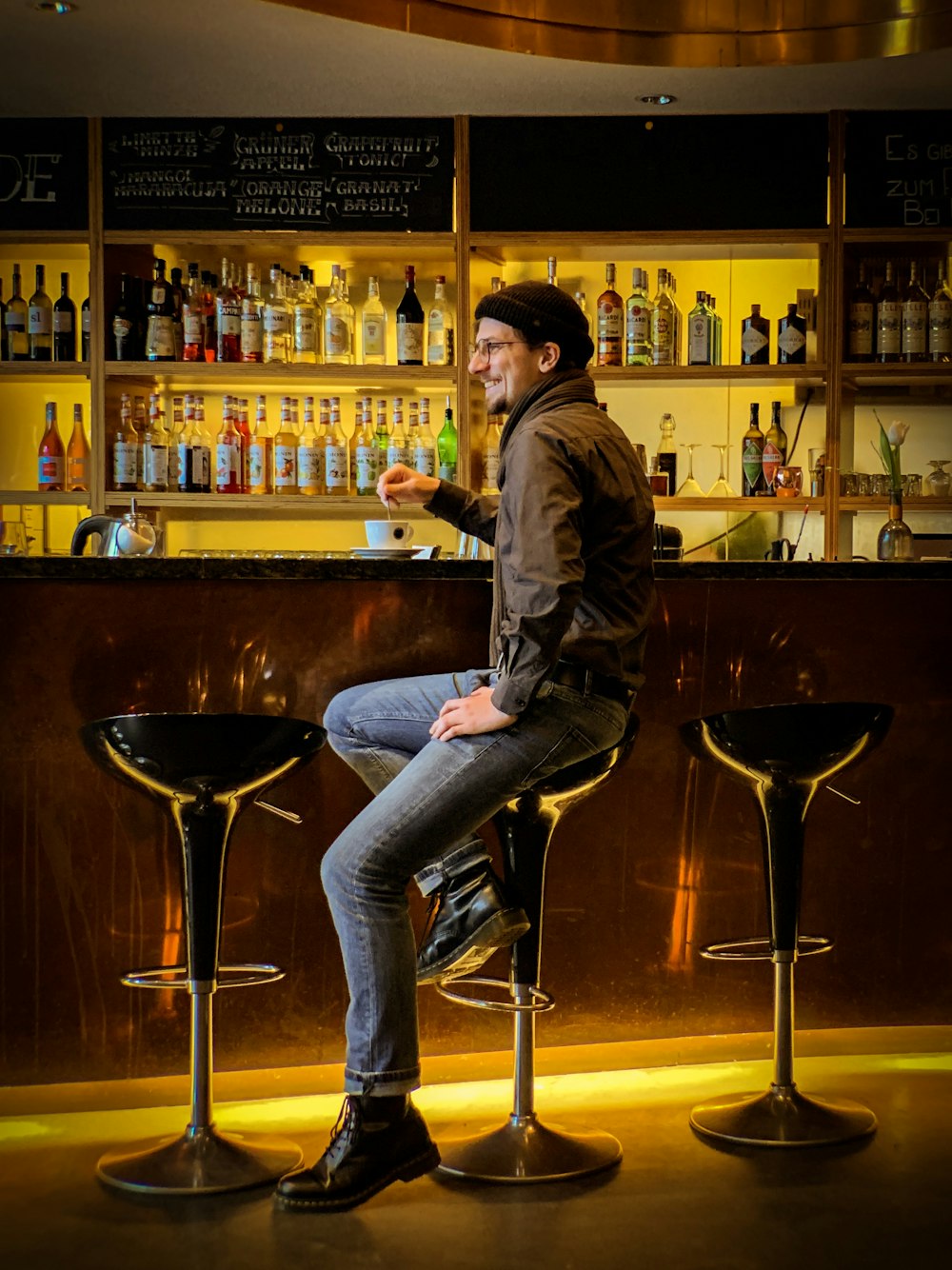 man sitting on hydraulic barstool