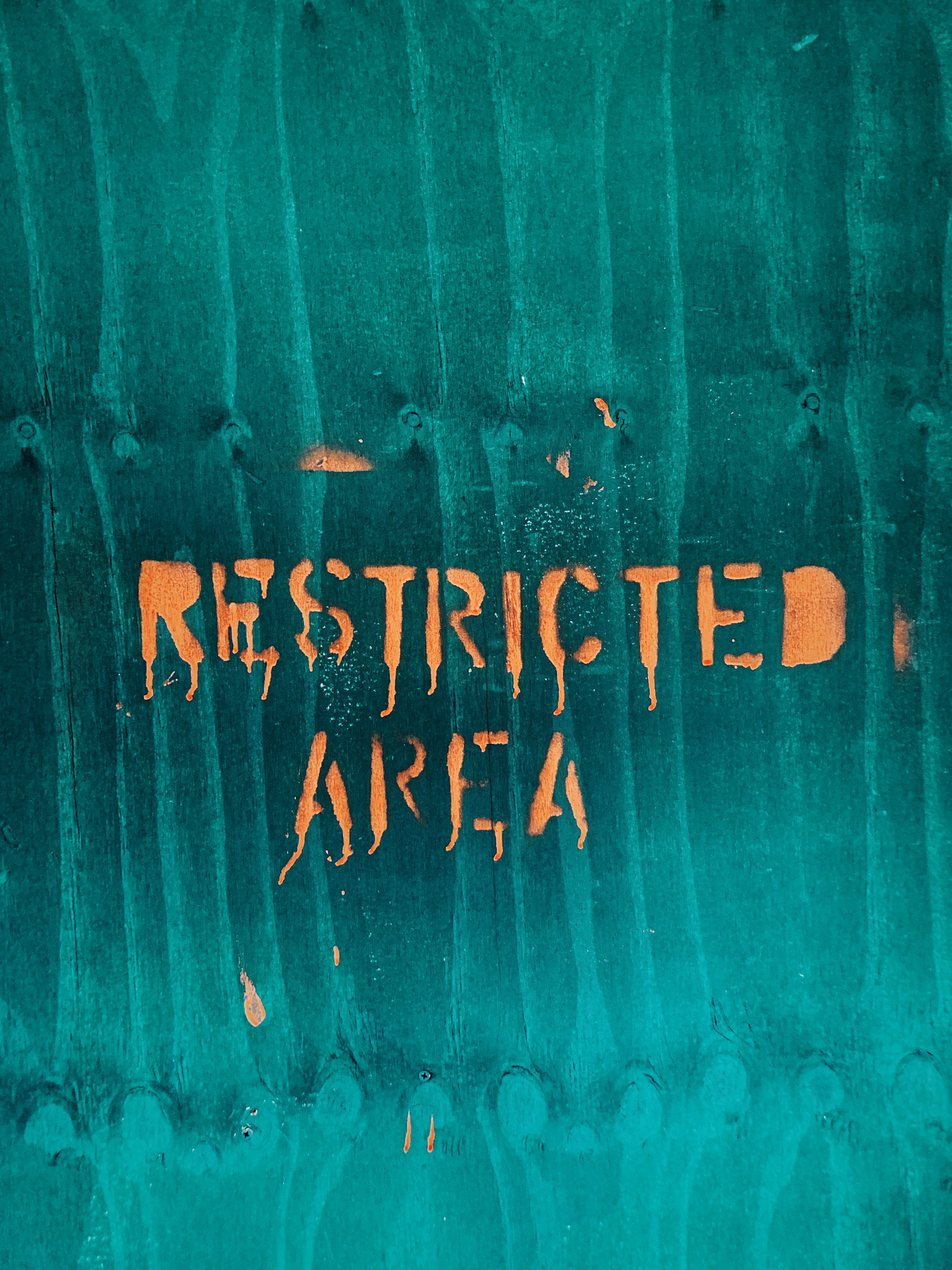 restricted area text with teal background