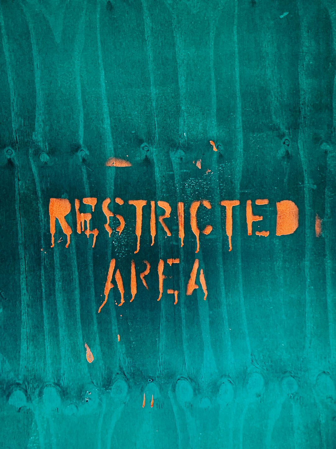 restricted area text with teal background