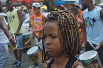 A group of young people playing reggae instruments in a community workshop.