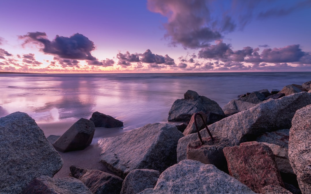 grey rocky shore during cloudy sunset