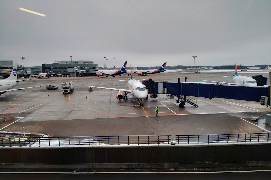 white airliner beside intermodal container,