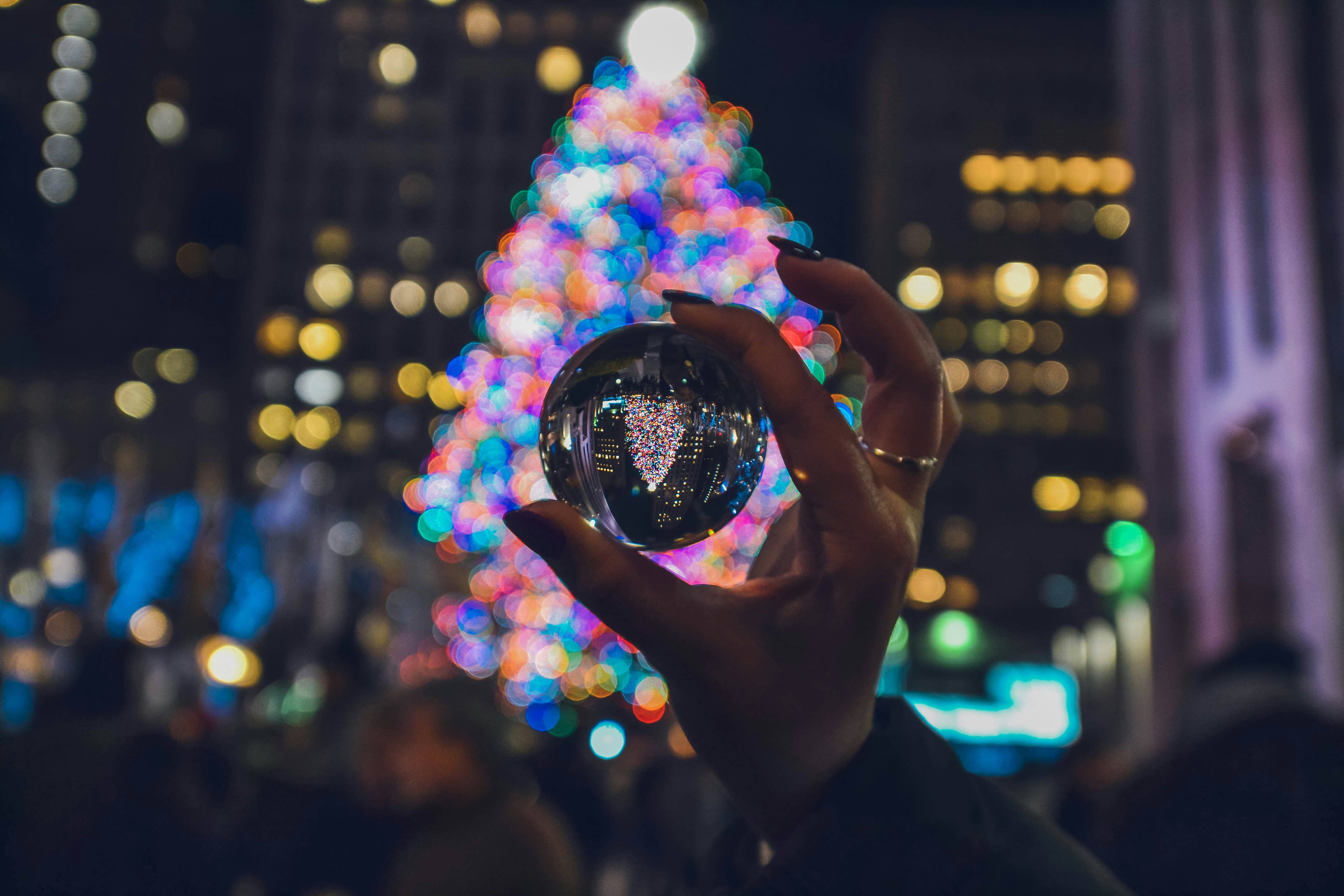 person holding clear glass ball