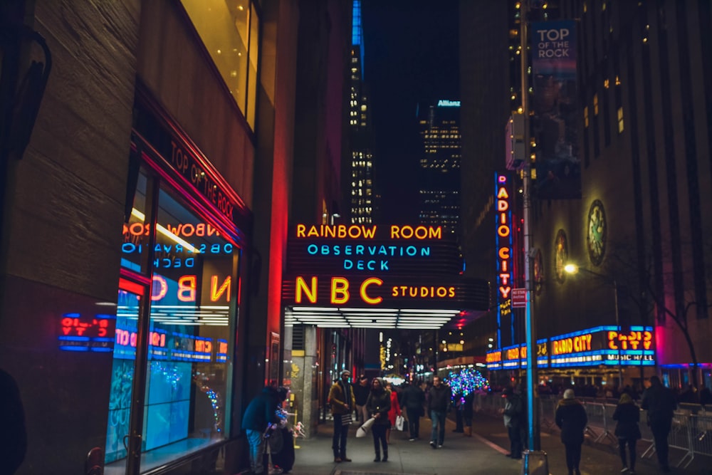 several people walking beside NBC Studios building