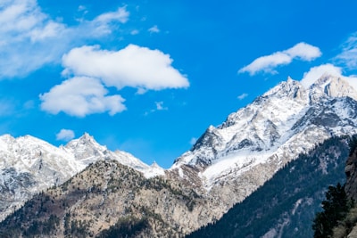 Snow-capped mountains under a clear blue sky, perfect for hiking.