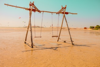 brown wooden swing on sand at Dakhla attitude hotel