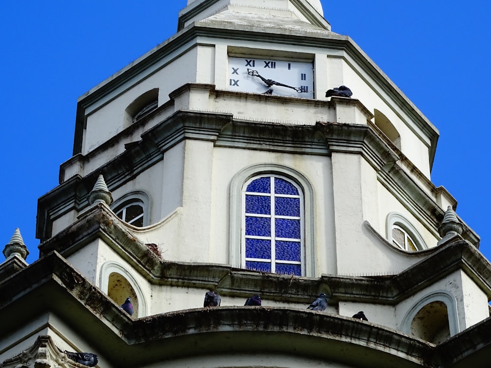 black and white house with clock displaying 9:15 time