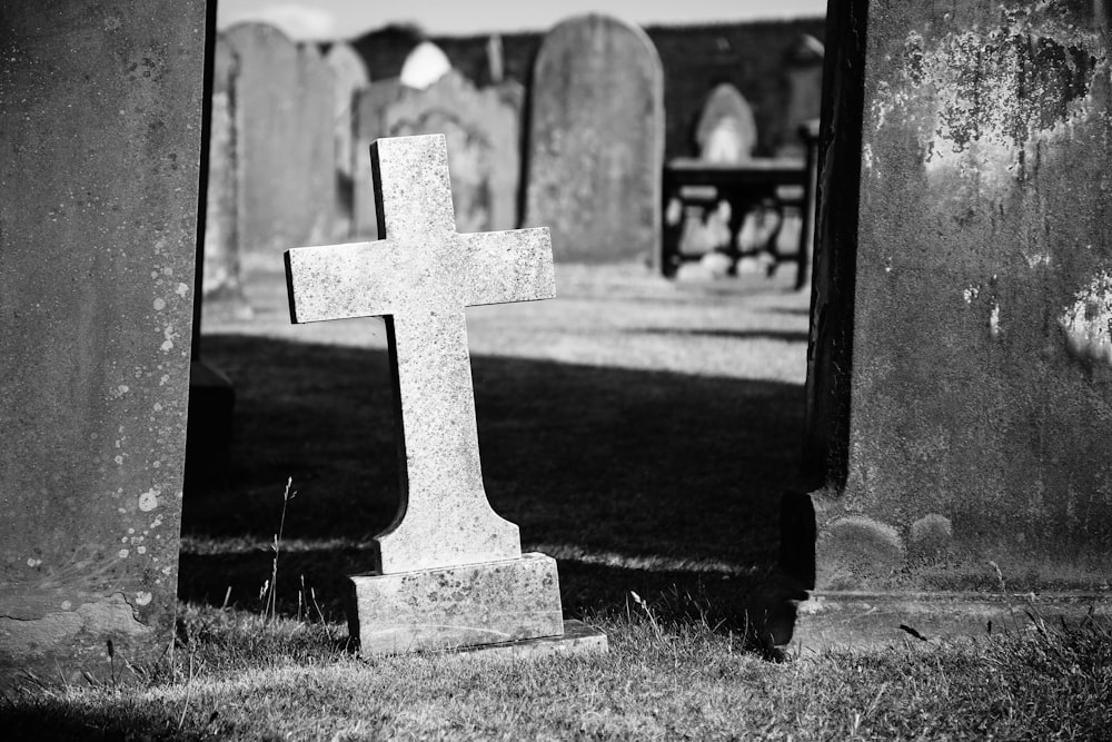grayscale photo of gray graveyard cross