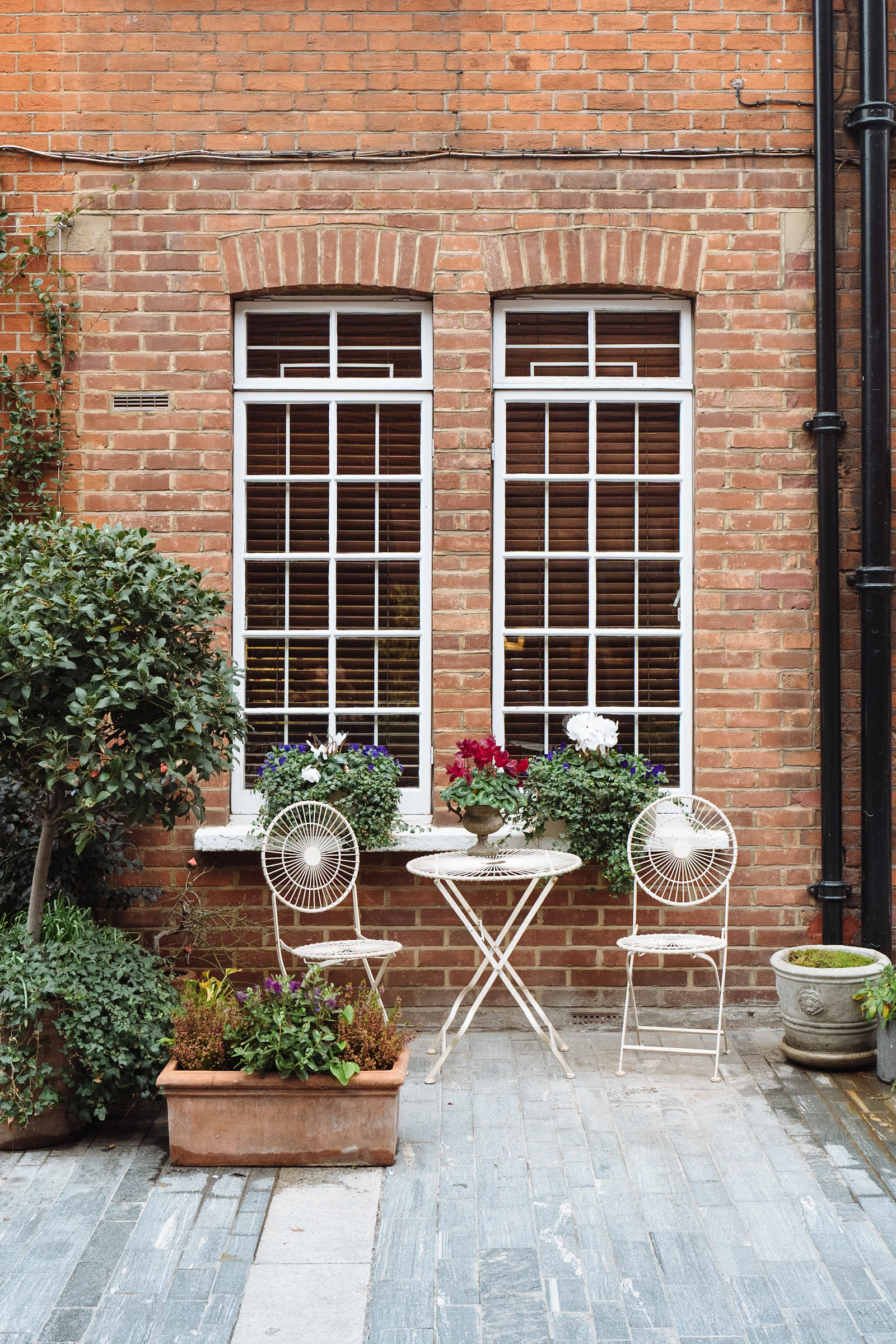 Brick townhouse facade with tall white sash windows