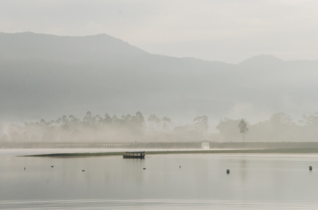 boat on water with mountain background