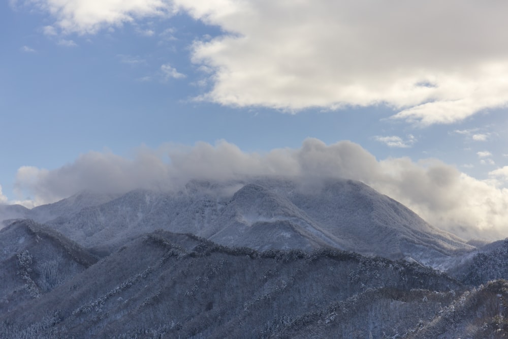 mountain under white cloudy skies during daytime