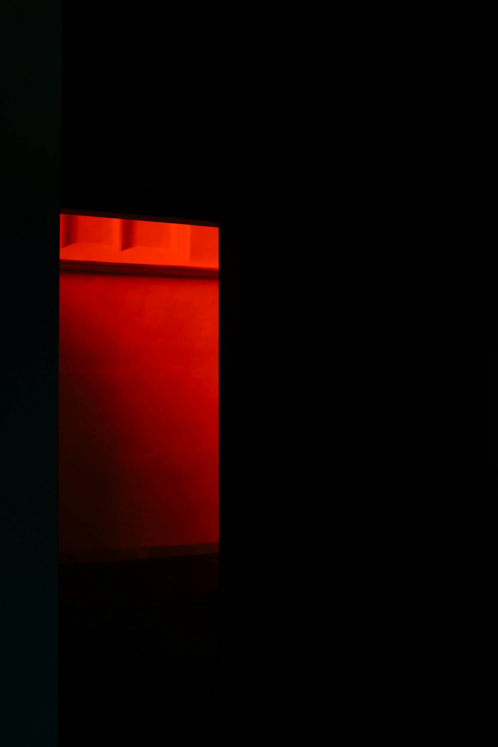 a black room with a red light in the corner