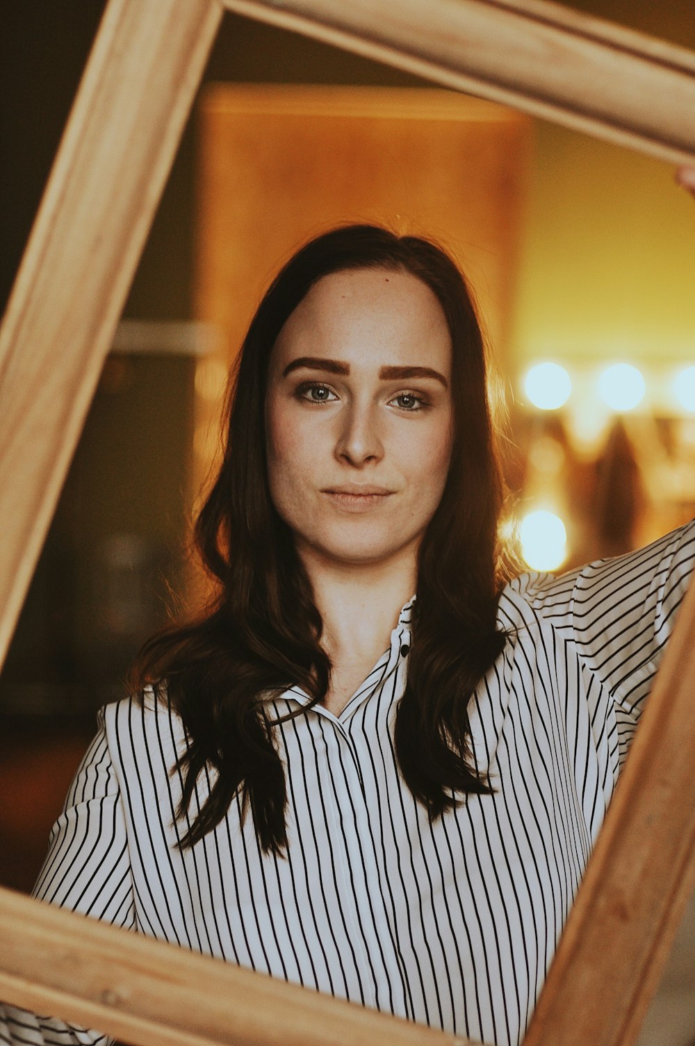 woman wearing white and black pinstriped top