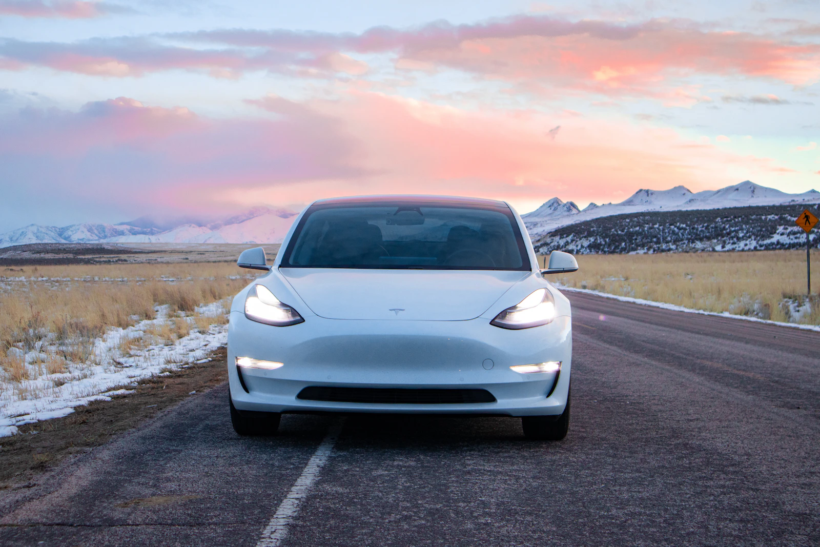 A white Tesla car on a road