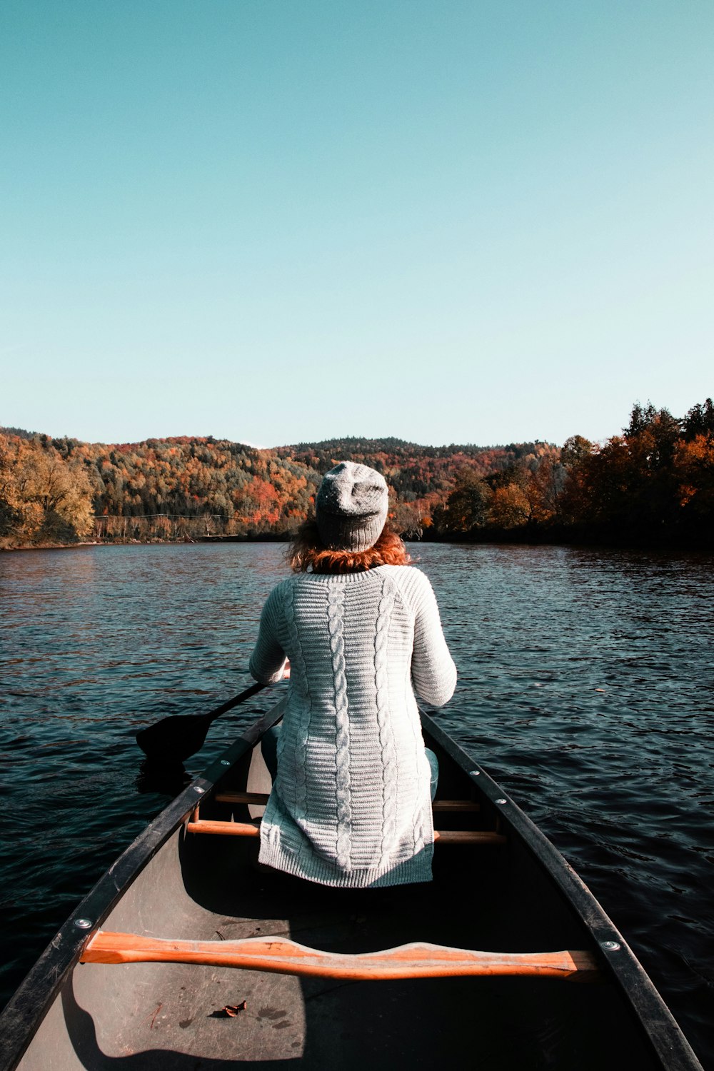 woman sitting on boat while paddling