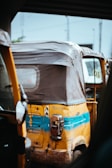 A close-up of an eco-friendly auto rickshaw showcasing its design.