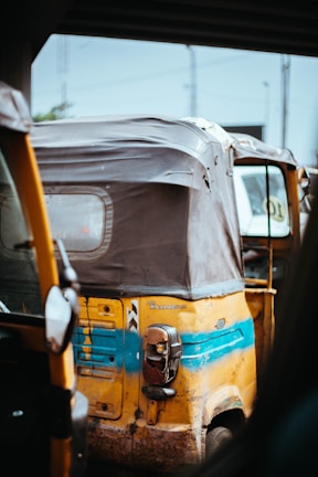 A close-up of an eco-friendly auto rickshaw showcasing its design.
