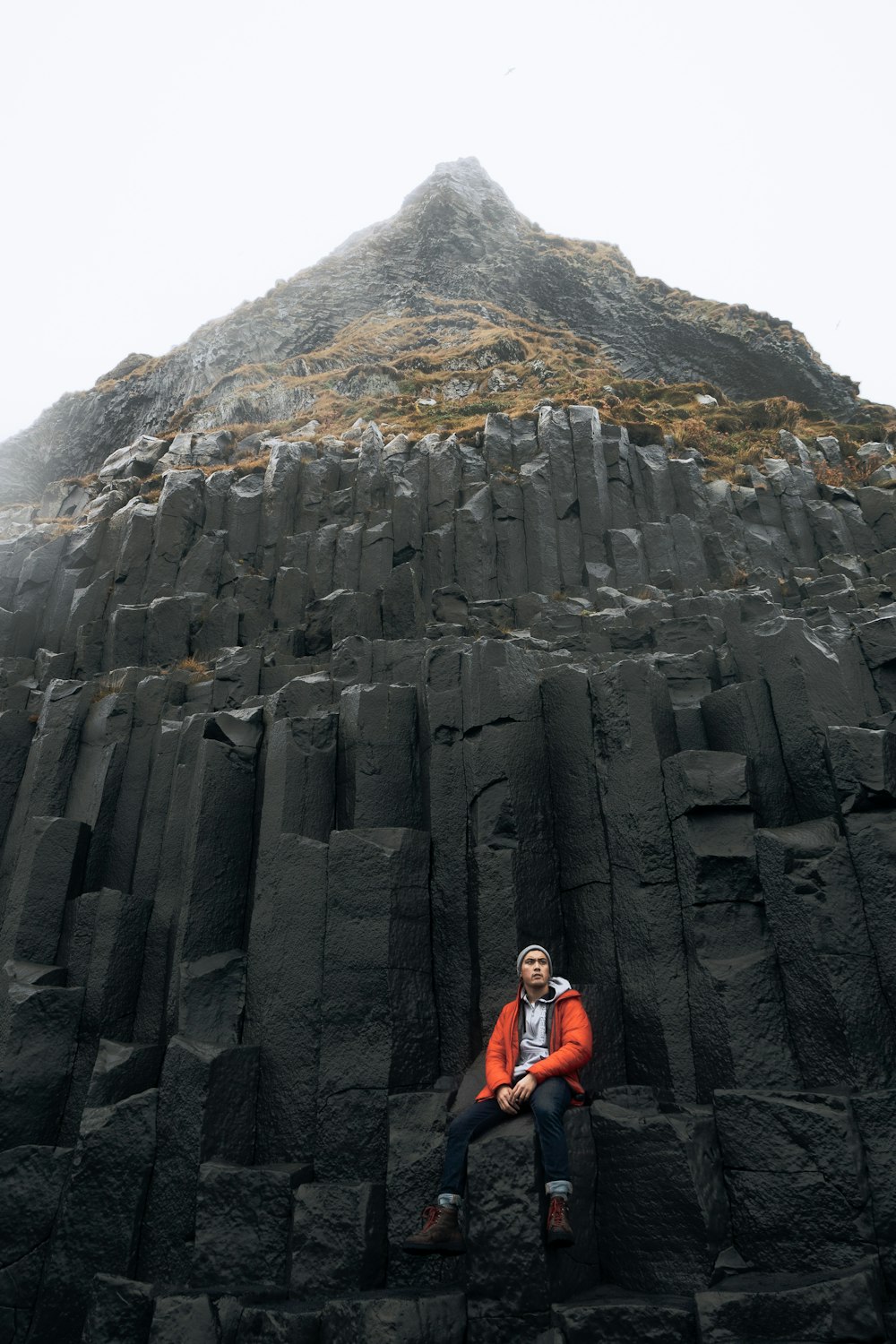 man sitting near mountain