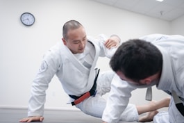 two men doing karate inside room