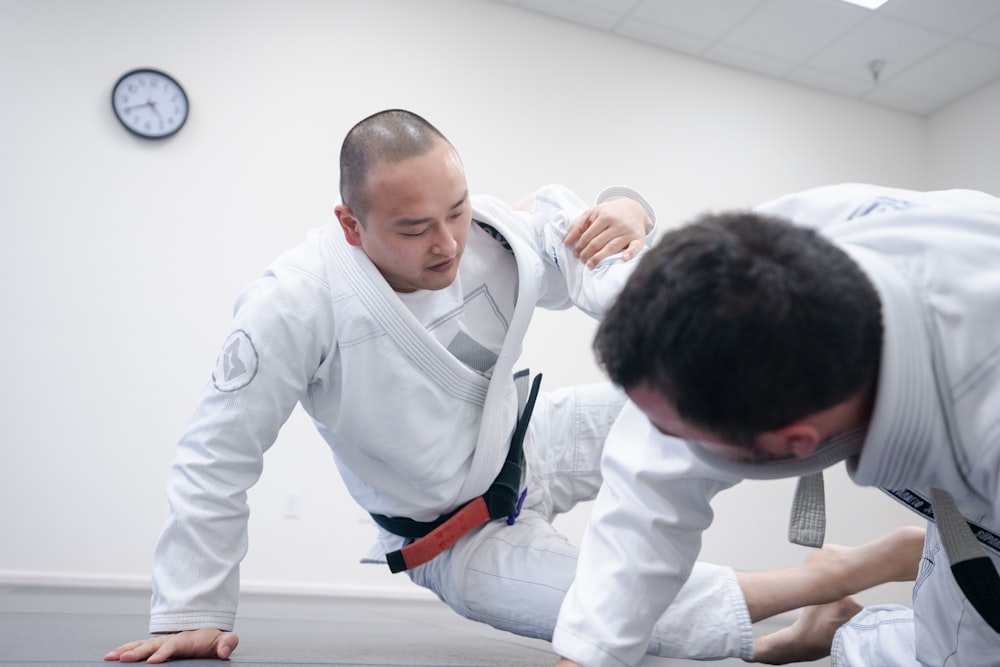 two men doing karate inside room