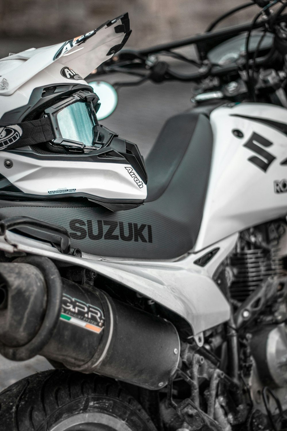 white Suzuki dirt bike with helmet