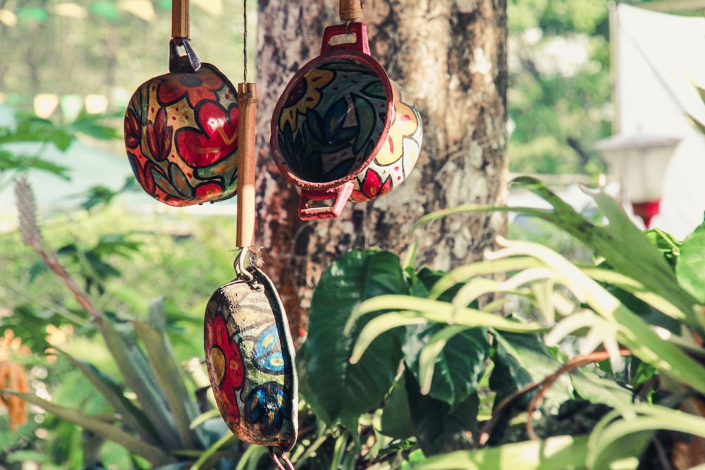 three assorted-color hanging pots at daytime