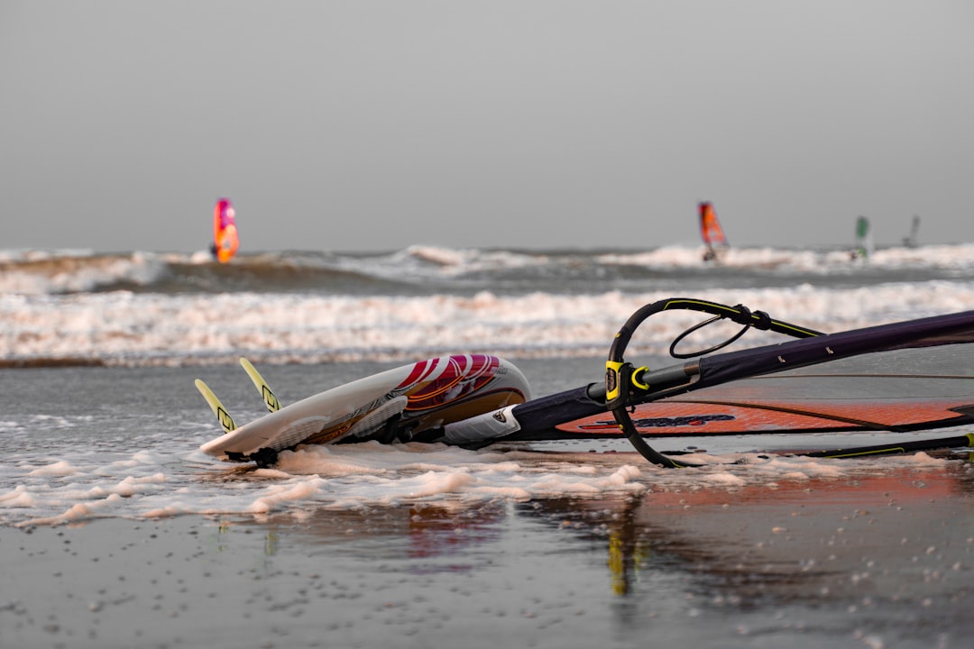 surfboard on seashore during daytime