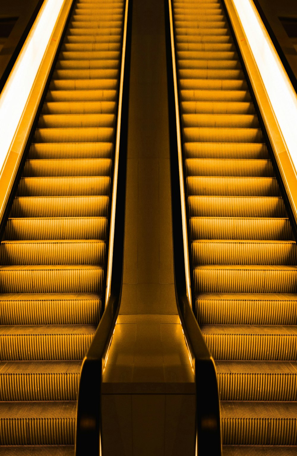 low-angle photography of two escalators