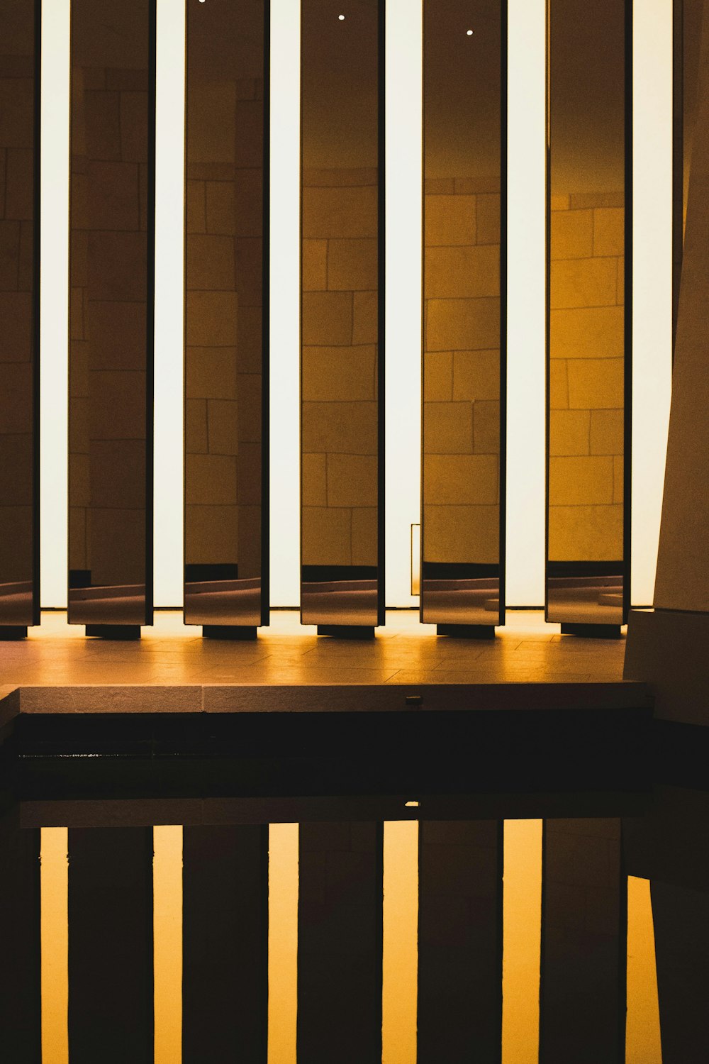 a reflection of a building in a pool of water