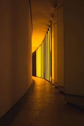 Warm, inviting hallway softly lit by automated architectural lighting at dusk.