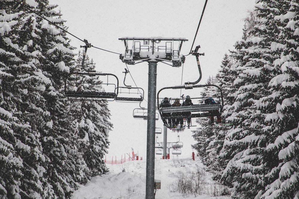 three people sitting on cable car