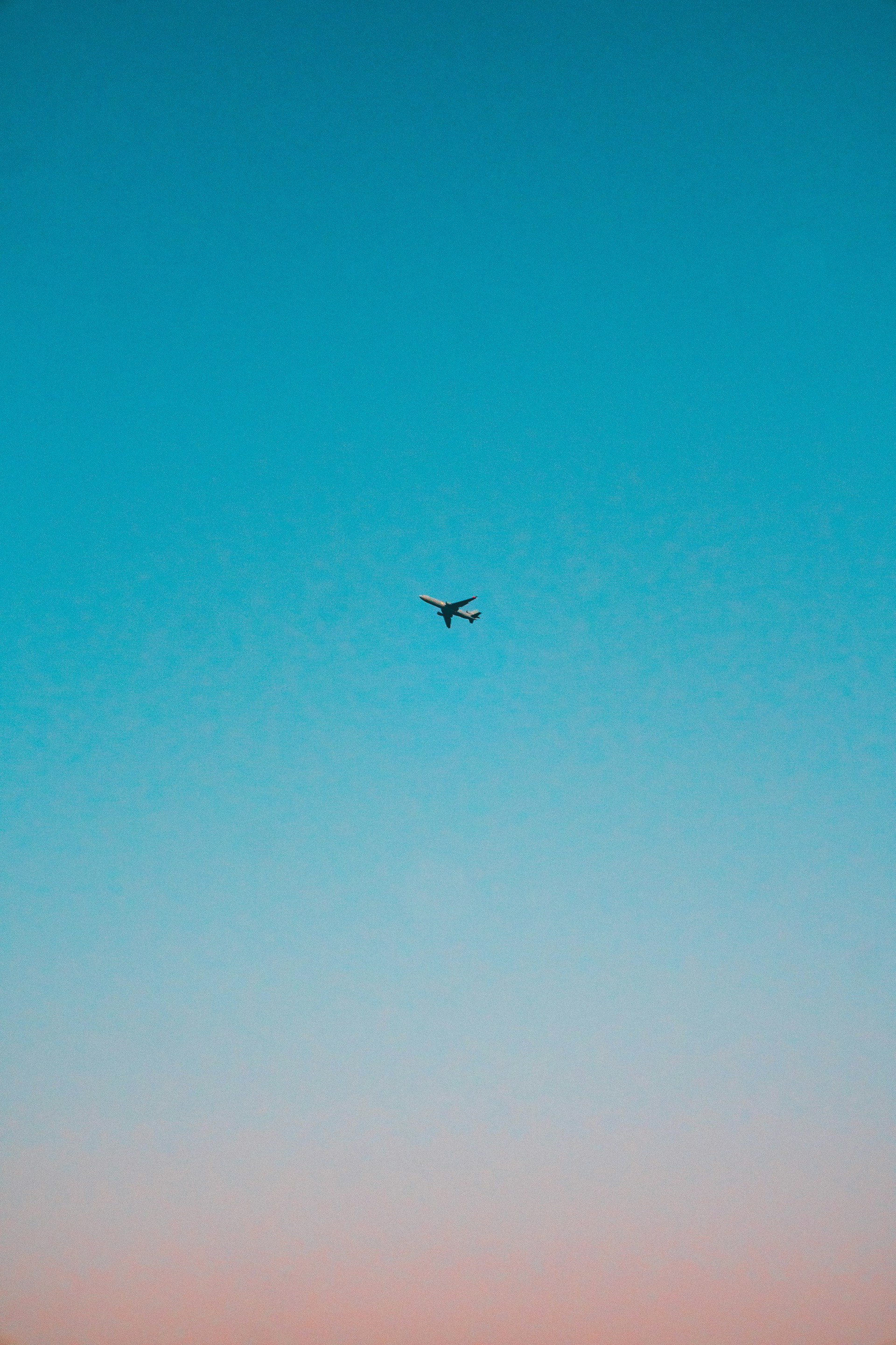 flying airplane under blue sky