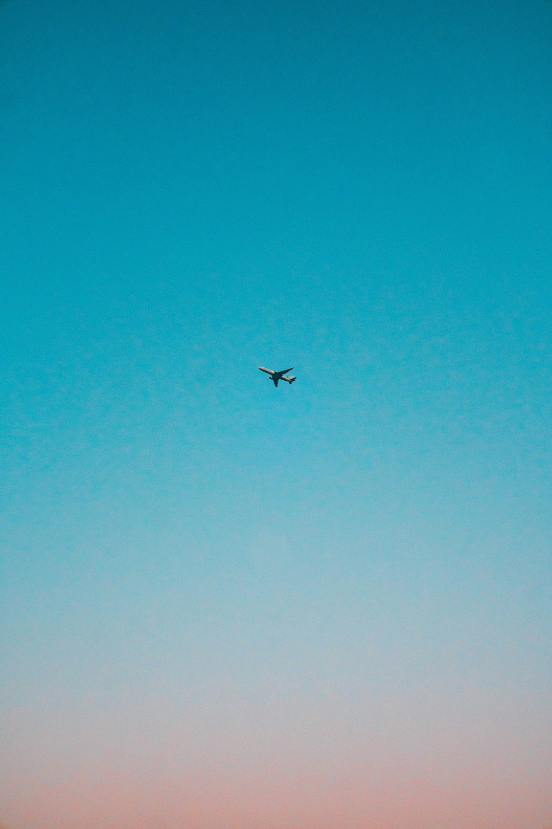 flying airplane under blue sky